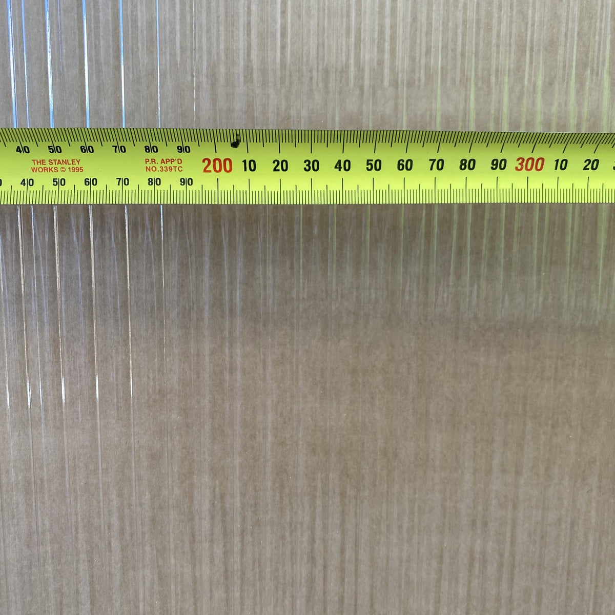Narrowline glass close-up with a tape measure across it, showing the 10mm flutes