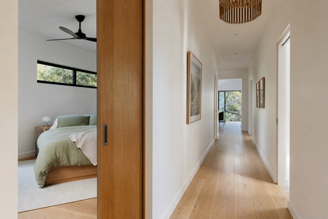 Timber cavity slider door half open into a bedroom in a modern Australian home