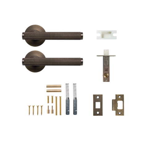 Door handle assembly with components on a white background. BellevueSolidBrassKnurledTubularLatchPassageLeverSetInBronze