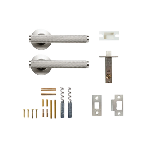 Door handle assembly with screws and springs on a white background. BellevueSolidBrassKnurledTubularLatchPassageLeverSetInDullBrushedNickel
