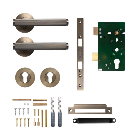 Door hardware components including handles, locks, and mechanisms on a white background. BellevueSolidBrassLinedLeverEntranceSetInDarkBrushedBrass