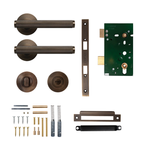 Door handle assembly with components on a white background. BellevueSolidBrassLinedMorticeLockPrivacyLeverSetInBronze