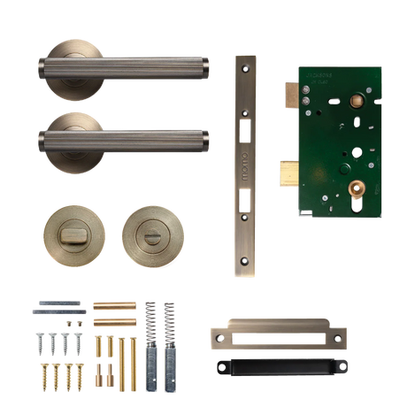 Door hardware components including handles, lock mechanisms, and screws on a white background. BellevueSolidBrassLinedMorticeLockPrivacyLeverSetInDarkBrushedBrass