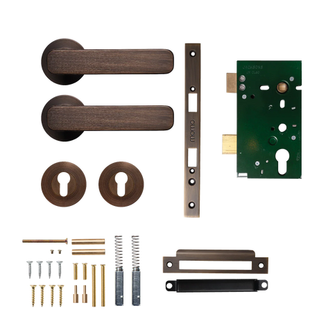 Door handle and lock assembly on a white background. MomoAspenSolidBrassLeverEntranceSetInBronze