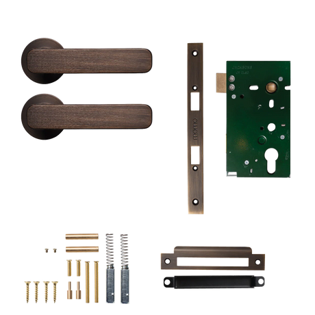 Door handle assembly with components on a white background. MomoAspenSolidBrassMorticeLockPassageLeverSetInBronze