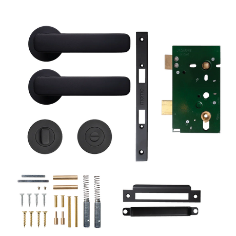 Door handle assembly kit with black handles, mortise lock, and screws on a white background. MomoAspenSolidBrassMorticeLockPrivacyLeverSetInMattBlack