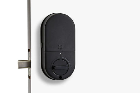 Black electronic door lock mounted on a white door. SmartDeadboltT13-back