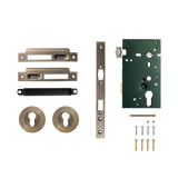 Door hardware kit with locks, handles, and screws on a white background. SolidBrassRollerMorticeEntranceSetInDarkBrushedBrass
